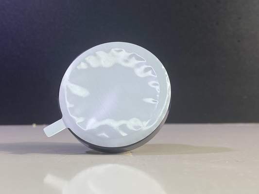 Couvercle de film compact thermiquement étanche pour poudre cosmétique pressée en poudre