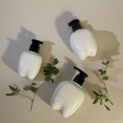 Bouteille en plastique en forme de dent de 100 à 250 ml avec pompe à pression pour le lavage des mains, lotion capillaire, désinfectant pour les mains, logo personnalisable